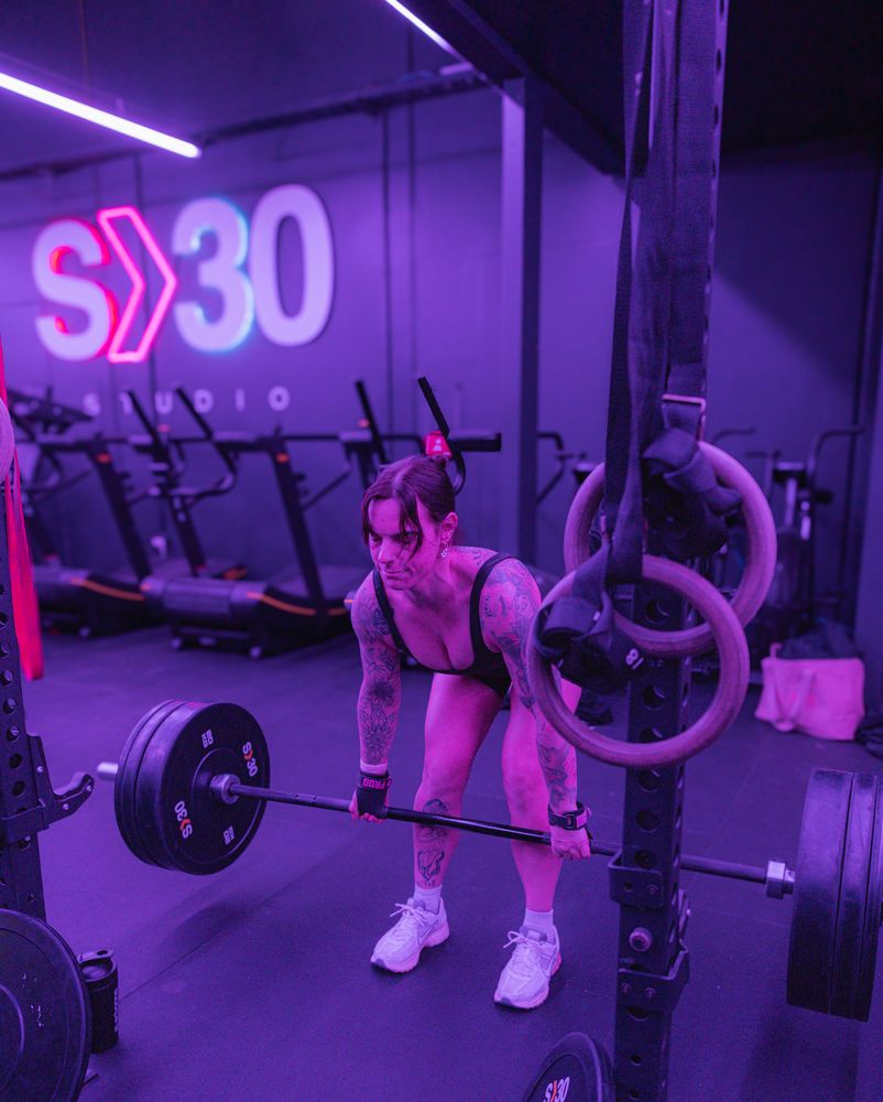 Member deadlifting in front of the S30 sign